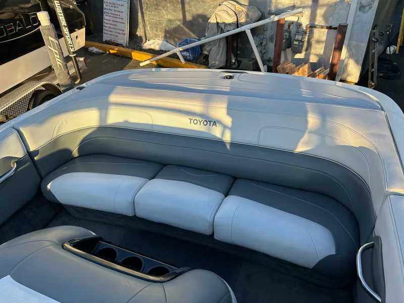 Slide: The Image of 1999 Toyota Epic 21 boat interior with gray seating and cup holders. - 6