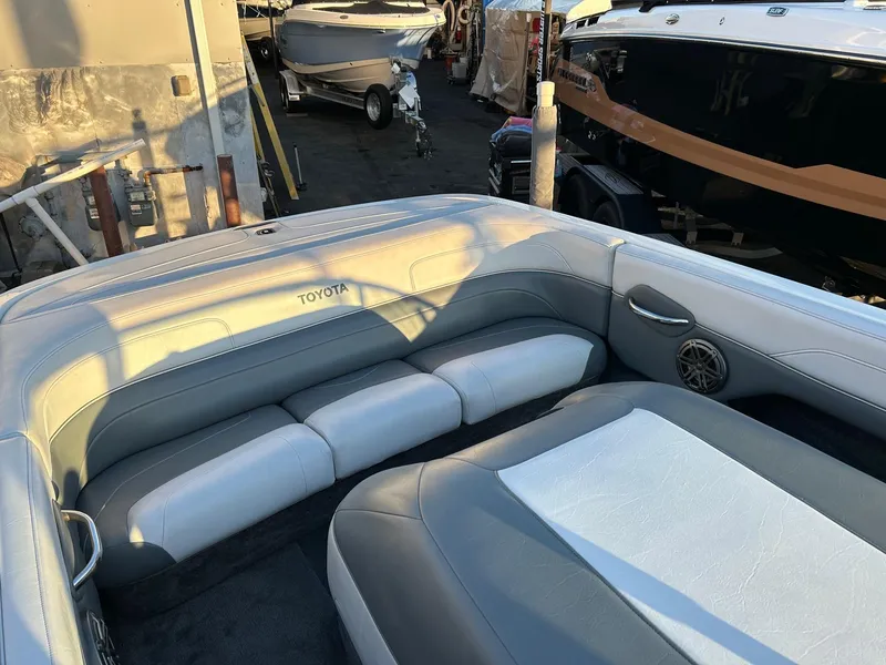 Slide: The Image of Interior of a 1999 Toyota Epic 21 boat with gray and white seating. - 7