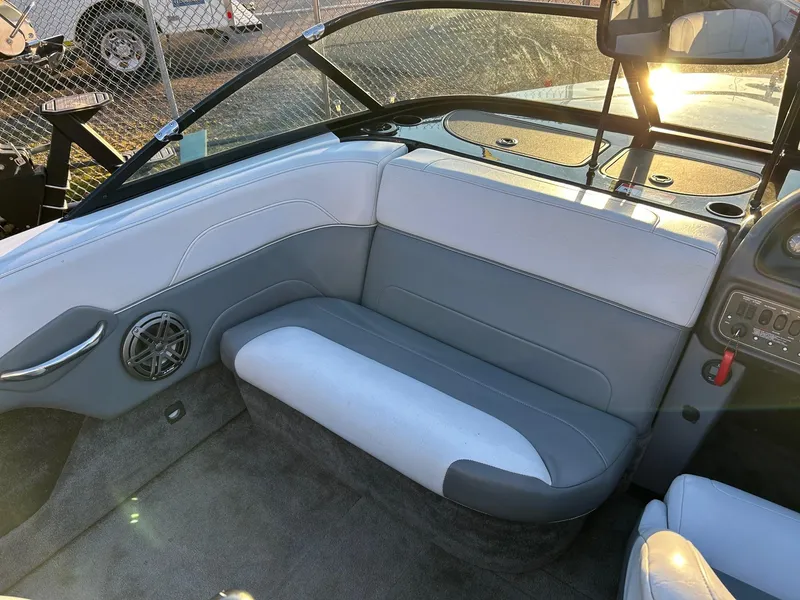 Slide: The Image of 1999 Toyota Epic 21 boat interior with gray and white seating, speaker, and dashboard controls. - 8