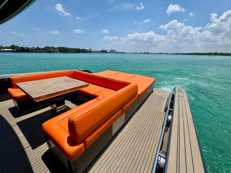 Slide: The Image of Luxury Pardo Yachts 50, 2023 model, with vibrant orange seating and scenic ocean view. - 10