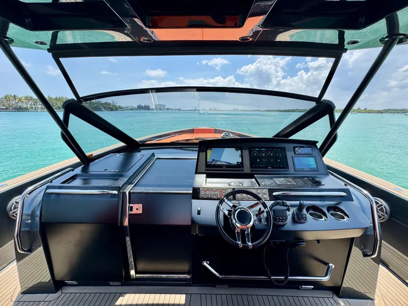 Slide: The Image of Cockpit view of 2023 Pardo Yachts 50, featuring modern controls and ocean backdrop. - 13