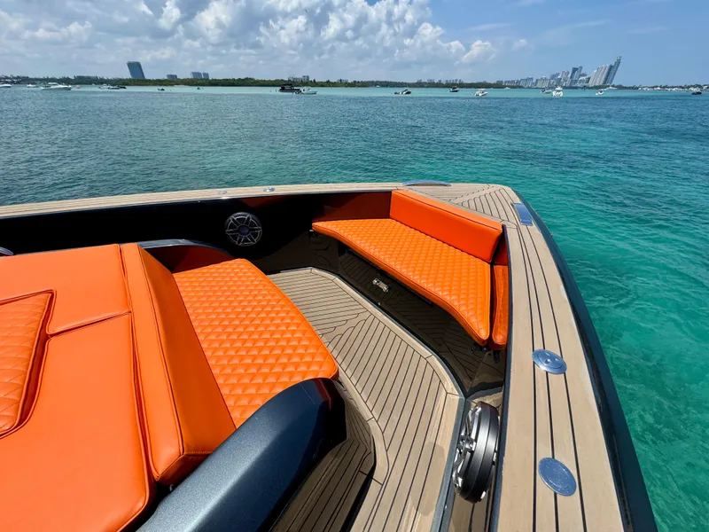 Slide: The Image of Luxurious 2023 Pardo Yachts 50 with vibrant orange seating, cruising on clear blue waters. - 15