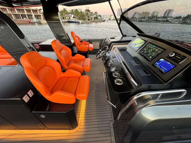Slide: The Image of Luxurious 2023 Pardo Yachts 50 cockpit with vibrant orange seats and advanced navigation systems. - 17