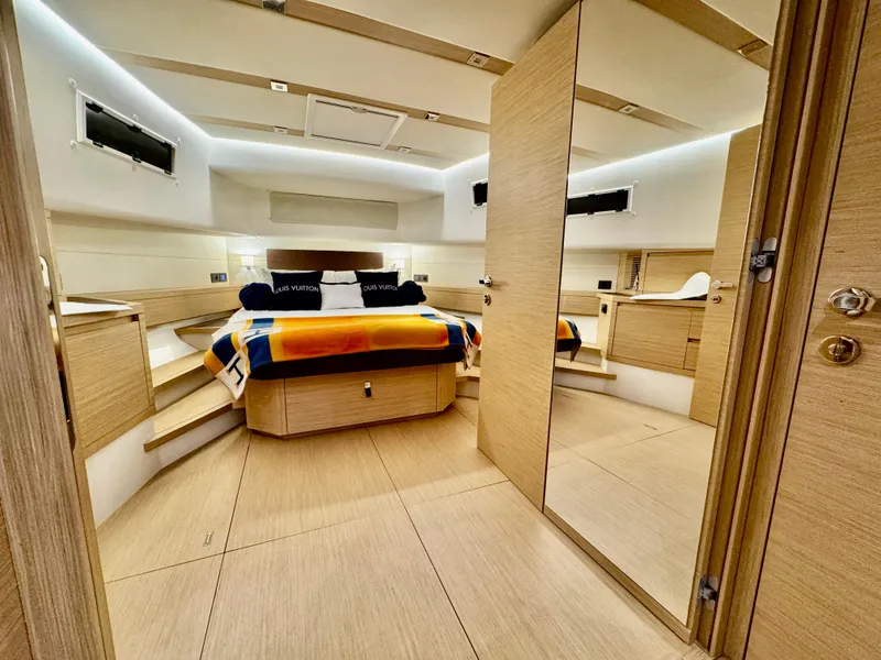 Slide: The Image of Luxurious interior of 2023 Pardo Yachts 50, featuring a modern bedroom with elegant wood finishes. - 21