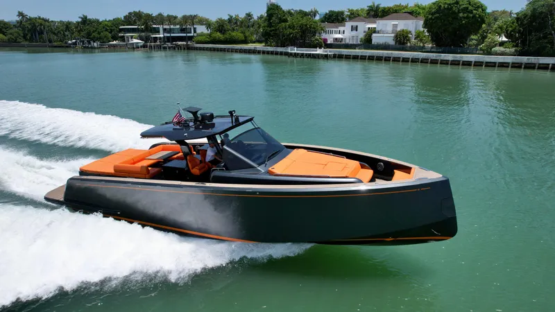 Slide: The Image of 2023 Pardo Yachts 50 cruising on a serene waterway with modern design and orange seating. - 3