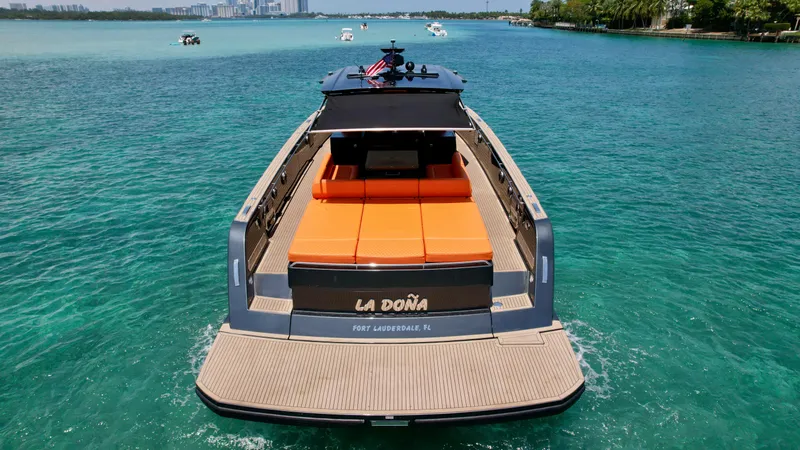 Slide: The Image of 2023 Pardo Yachts 50 on turquoise water, rear view with orange seating. - 6