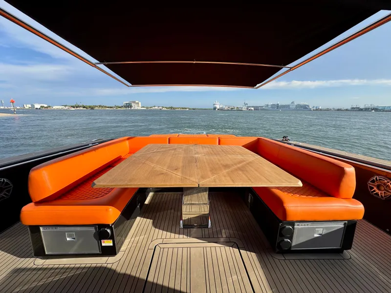 Slide: The Image of Luxury 2023 Pardo Yachts 50 with orange seating and wooden table on deck. - 7