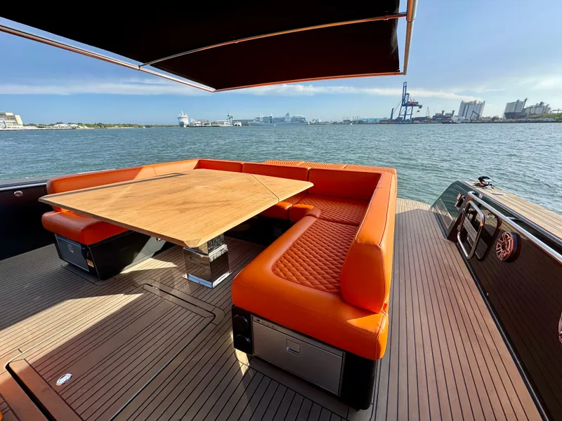 Slide: The Image of Luxury 2023 Pardo Yachts 50 with orange seating and wooden table on deck. - 9