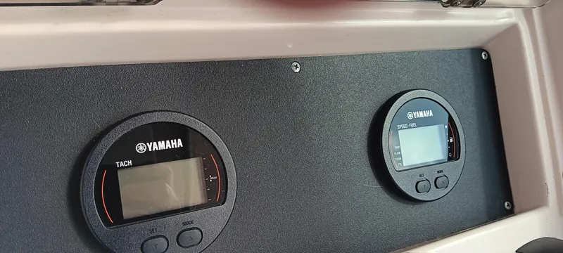 Slide: The Image of Yamaha gauges on a 1997 Grady-White Seafarer 226 boat dashboard. - 11