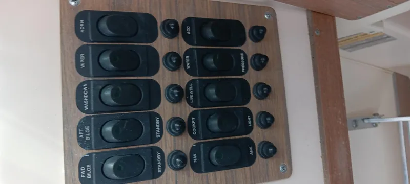 Slide: The Image of Control panel on a 1997 Grady-White Seafarer 226 boat with labeled switches. - 12