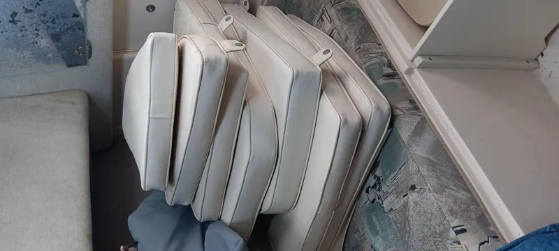 Slide: The Image of Cushions stacked inside a 1997 Grady-White Seafarer 226 boat cabin. - 15