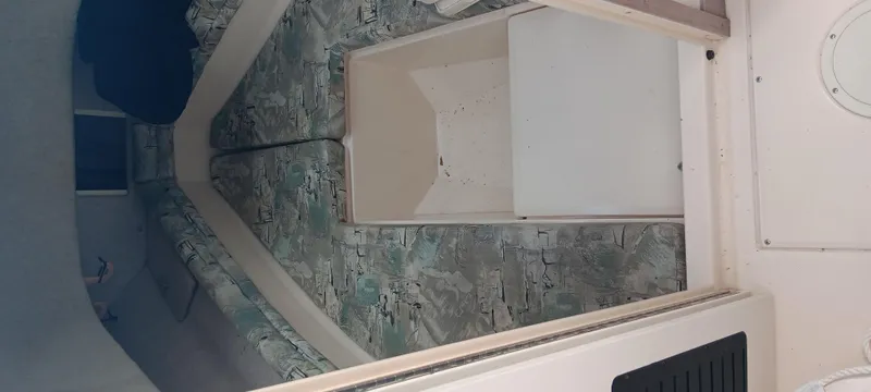 Slide: The Image of 1997 Grady-White Seafarer 226 cabin interior with patterned cushions and storage compartment. - 16