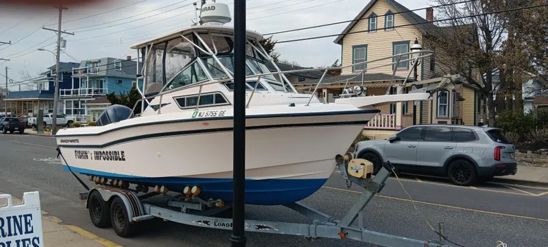 Slide: The Image of 1997 Grady-White Seafarer 226 boat on trailer, parked on street near houses. - 3
