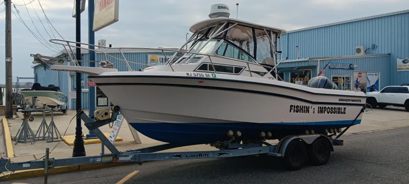 Slide: The Image of 1997 Grady-White Seafarer 226 boat on trailer outside a marine shop. - 4