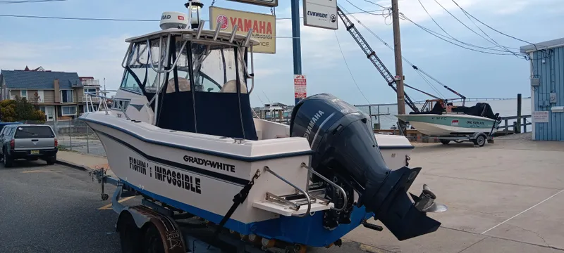 Slide: The Image of 1997 Grady-White Seafarer 226 boat on trailer, parked near Yamaha sign. - 5