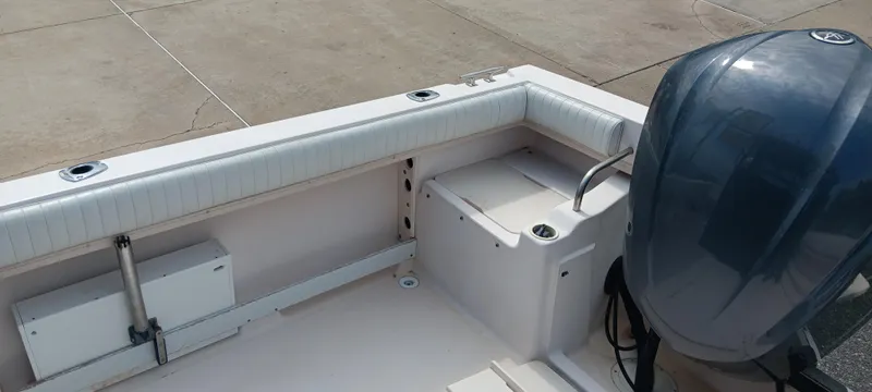 Slide: The Image of 1997 Grady-White Seafarer 226 boat interior with motor, showcasing seating and storage. - 7