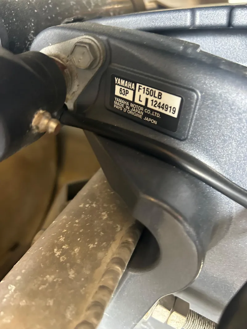 Slide: The Image of Close-up of a Yamaha F150LB engine part on a 2021 Avalon Catalina 24' boat. - 12