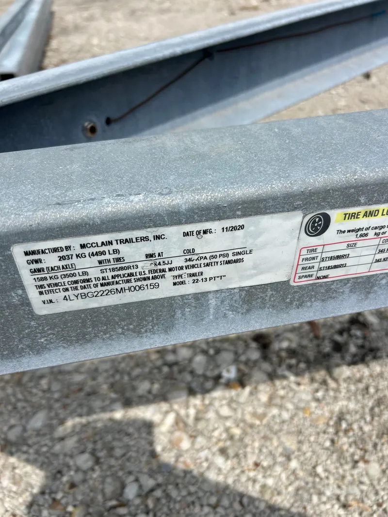 Slide: The Image of Close-up of a McClain trailer label on a 2021 Avalon Catalina 24' boat trailer. - 13
