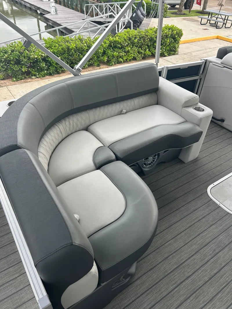 Slide: The Image of 2021 Avalon Catalina 24' boat with gray seating and sleek design. - 19