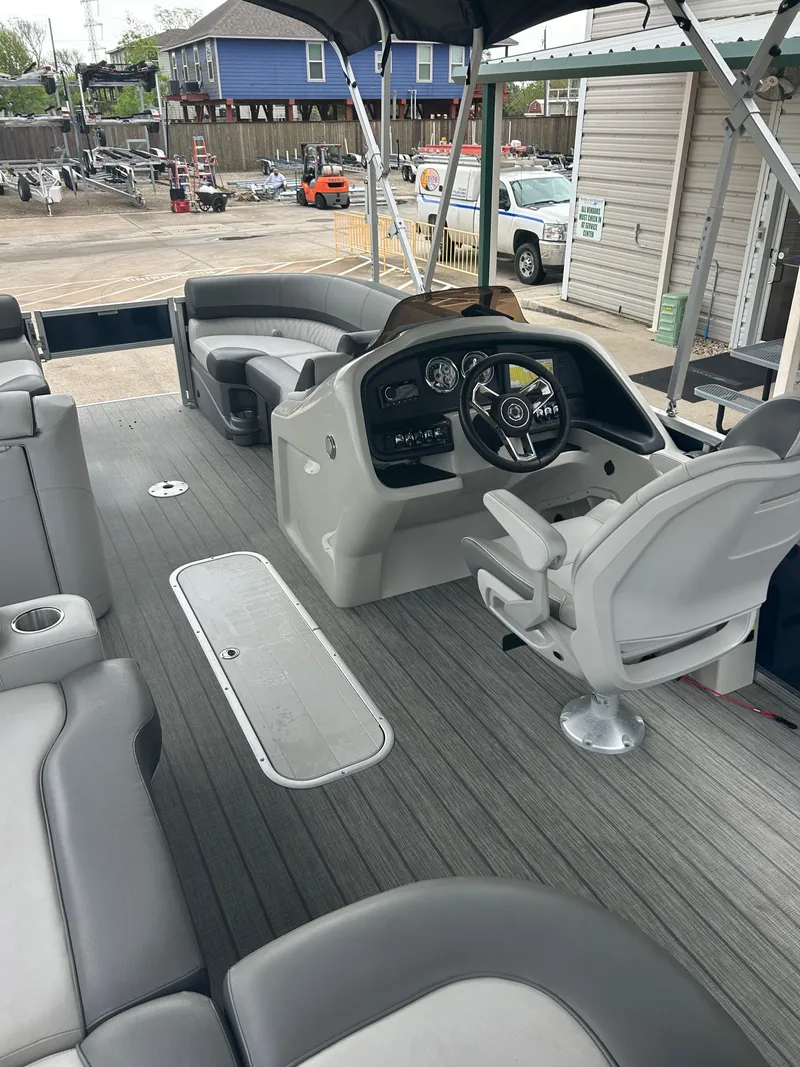 Slide: The Image of 2021 Avalon Catalina 24' boat interior with modern helm and seating. - 20