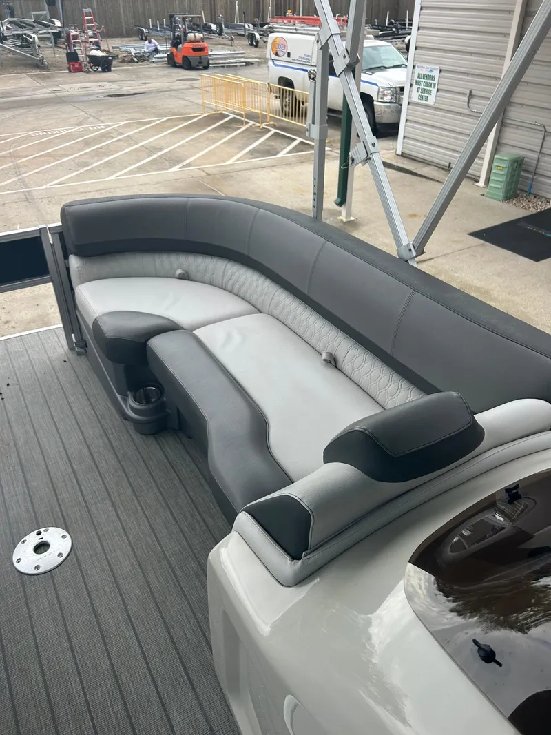 Slide: The Image of 2021 Avalon Catalina 24' boat with gray seating and deck, docked at marina. - 21