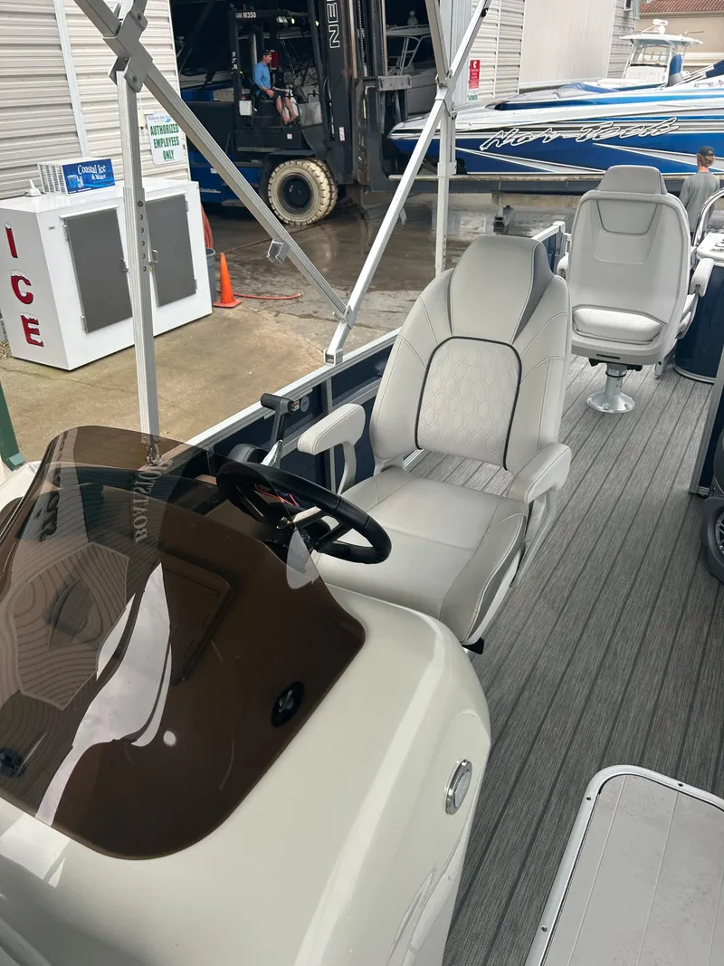 Slide: The Image of 2021 Avalon Catalina 24' boat interior with modern seating and steering console. - 22