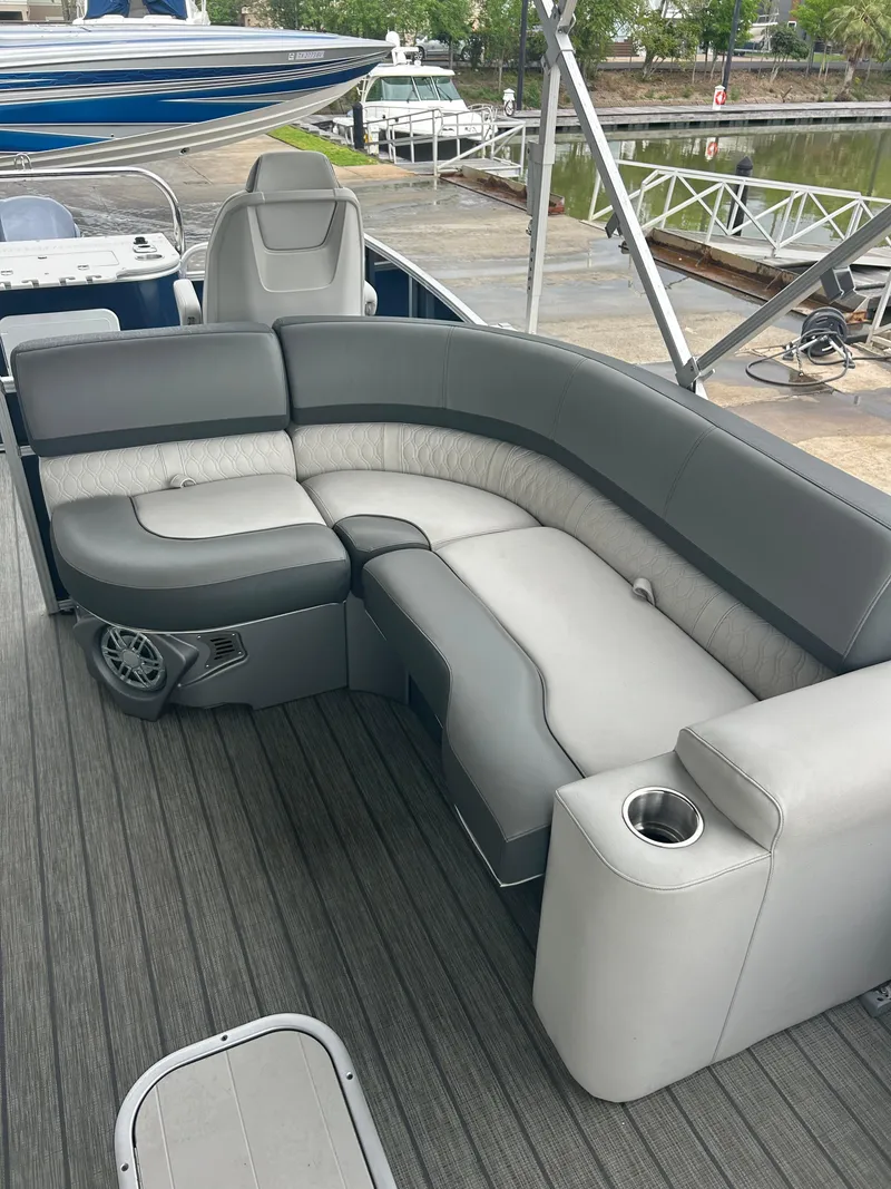 Slide: The Image of 2021 Avalon Catalina 24' boat interior with gray seating and cup holder. - 23