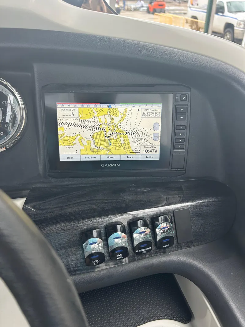 Slide: The Image of Dashboard of 2021 Avalon Catalina 24' with Garmin navigation system and control switches. - 27