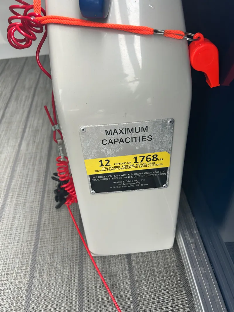 Slide: The Image of 2021 Avalon Catalina boat capacity label, 12 persons or 1768 lbs, red safety cord visible. - 29