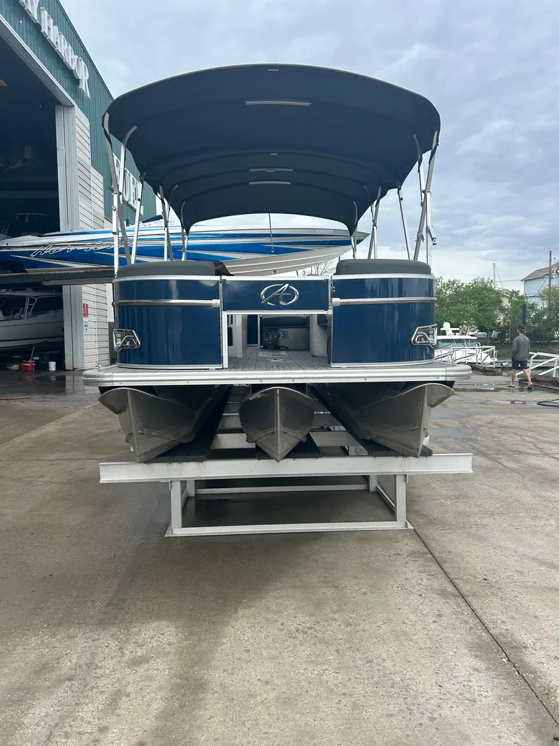 Slide: The Image of 2021 Avalon Catalina 24' pontoon boat on a lift at a marina. - 3