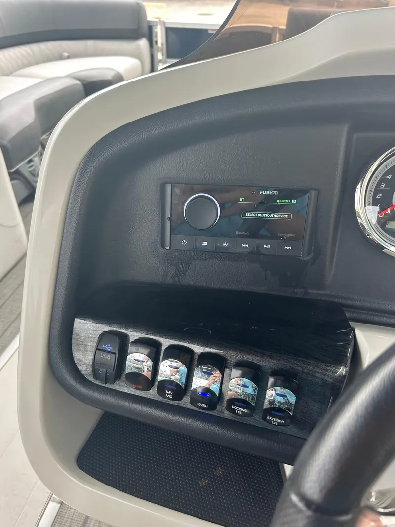 Slide: The Image of Control panel of 2021 Avalon Catalina 24' boat with switches and stereo system. - 31