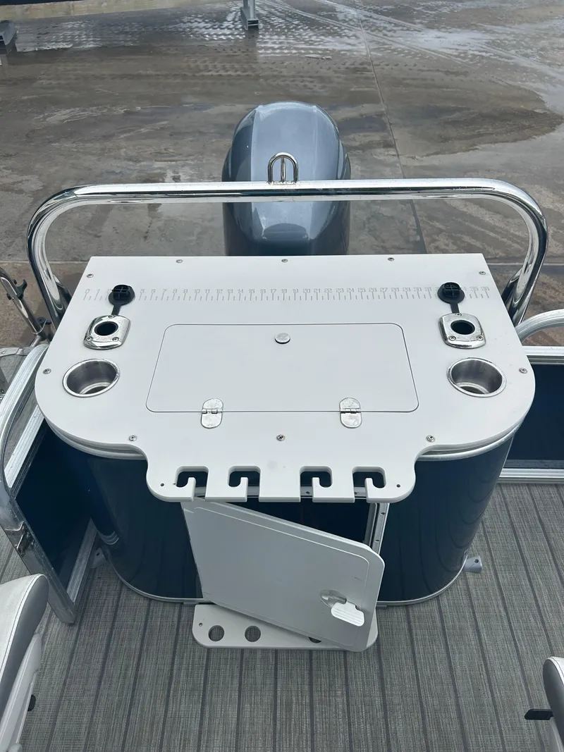 Slide: The Image of 2021 Avalon Catalina 24' boat console with storage and cup holders. - 36
