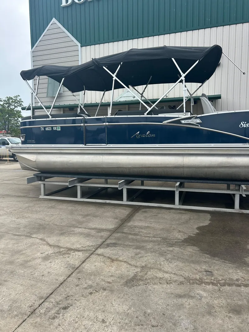 Slide: The Image of 2021 Avalon Catalina 24' pontoon boat with black canopy on display. - 5
