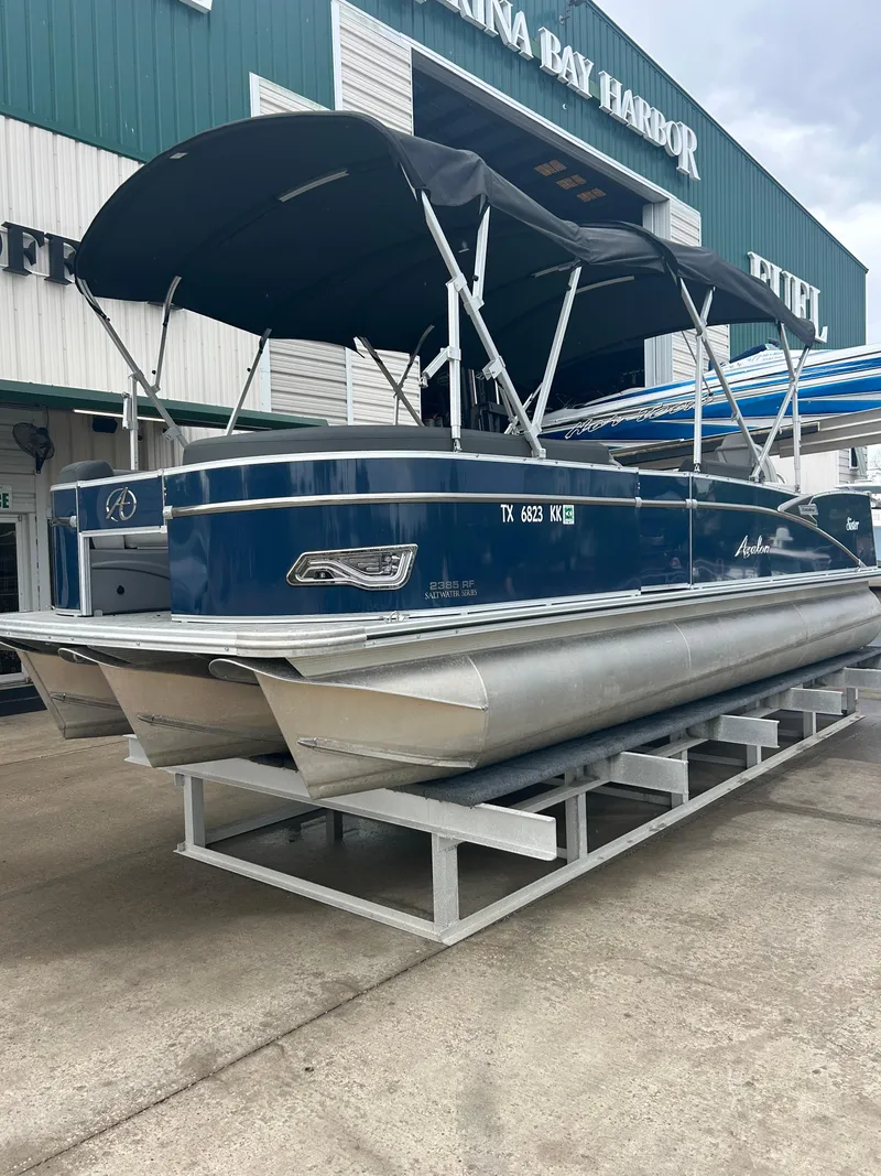 Slide: The Image of 2021 Avalon Catalina 24' pontoon boat with canopy, displayed at marina. - 6