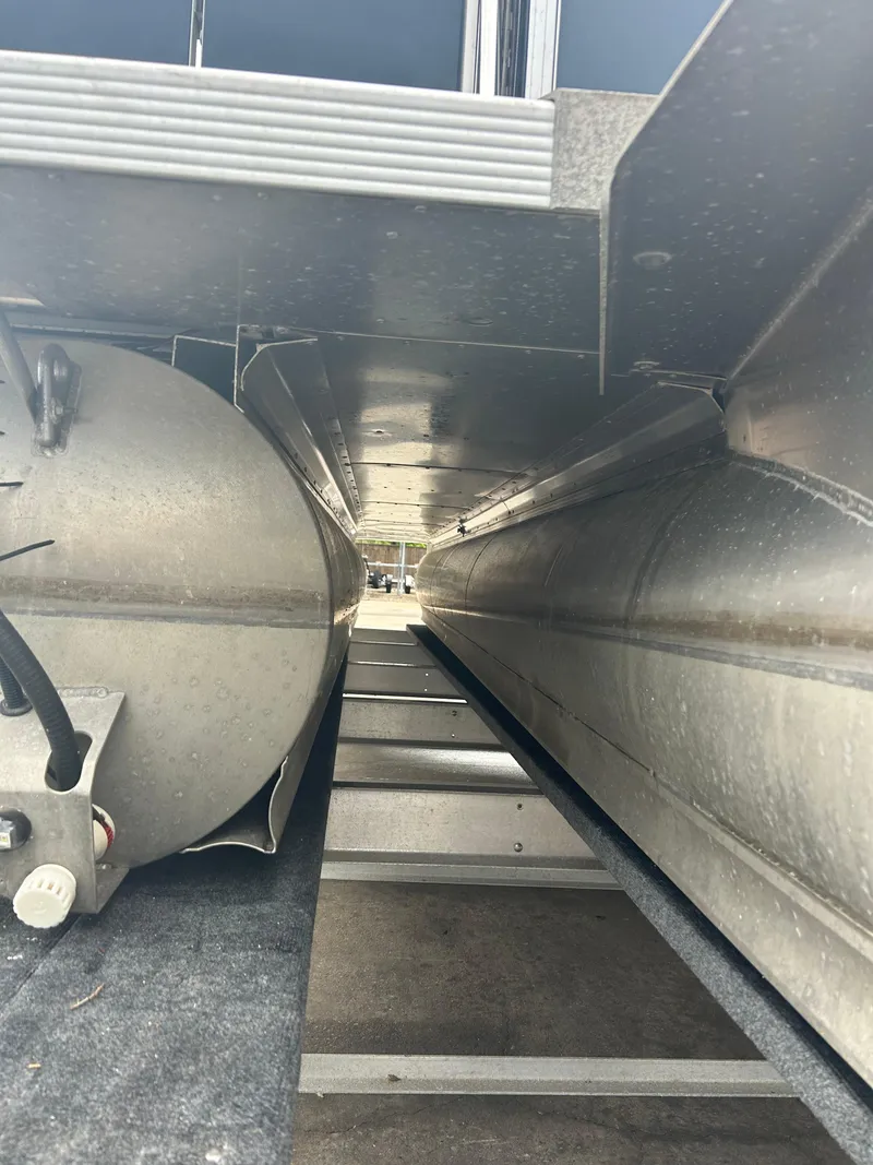Slide: The Image of Underneath view of a 2021 Avalon Catalina 24' pontoon boat, showcasing its structure and pontoons. - 7