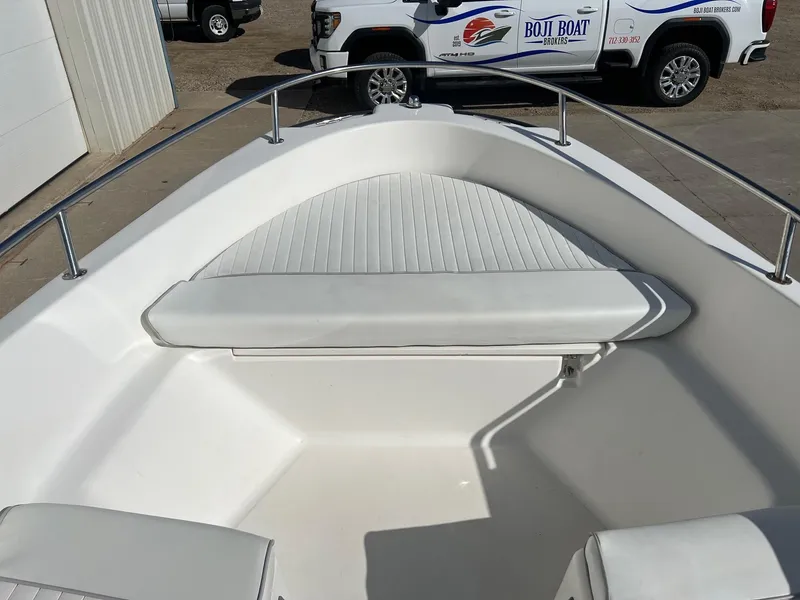 Slide: The Image of 1995 Boston Whaler 170 Dauntless boat interior with white seating and railing. - 10