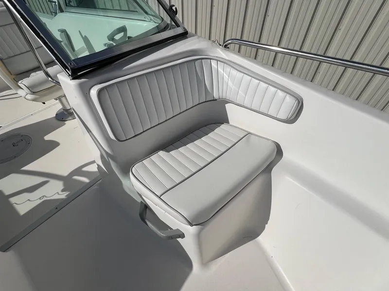 Slide: The Image of 1995 Boston Whaler 170 Dauntless boat seat with white upholstery and windshield. - 13