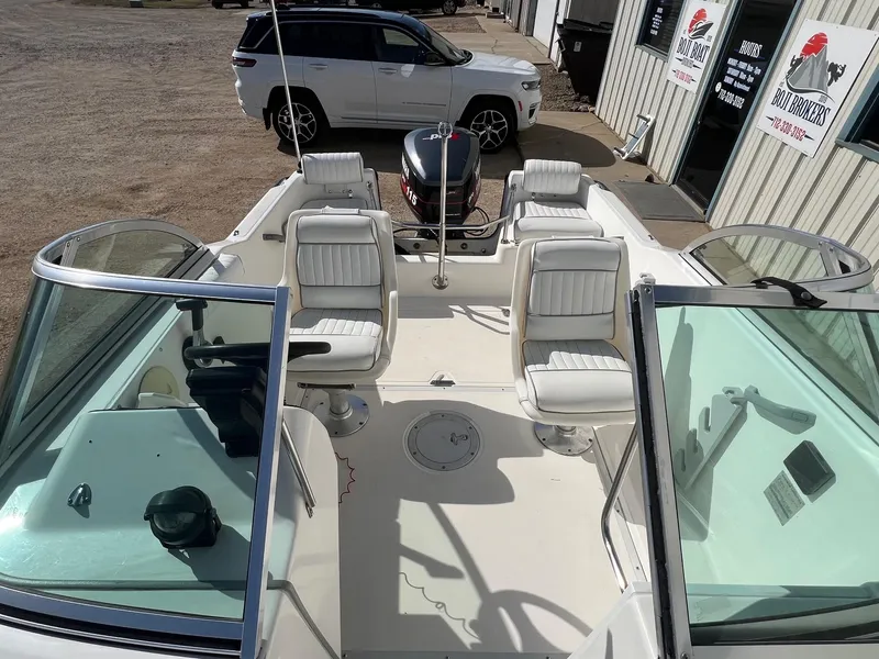 Slide: The Image of 1995 Boston Whaler 170 Dauntless boat interior with white seating and windshield. - 14