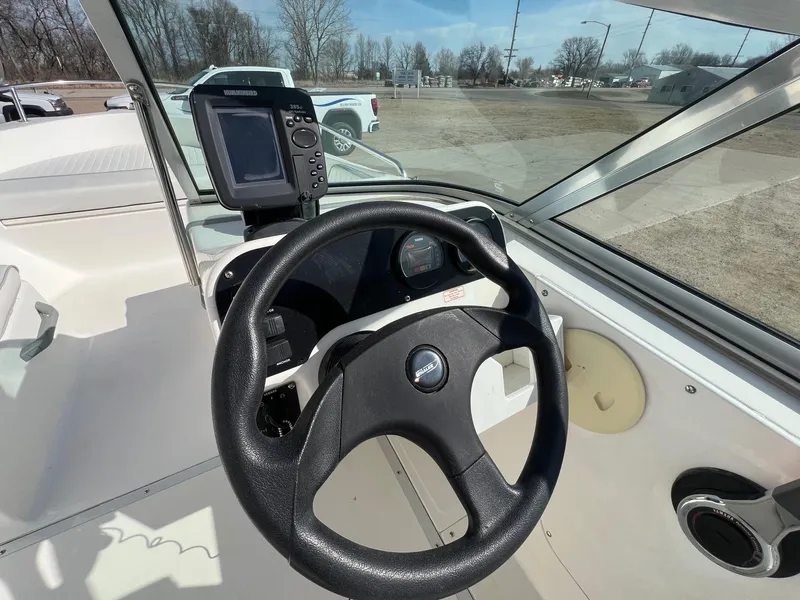 Slide: The Image of Steering wheel and dashboard of a 1995 Boston Whaler 170 Dauntless boat. - 15