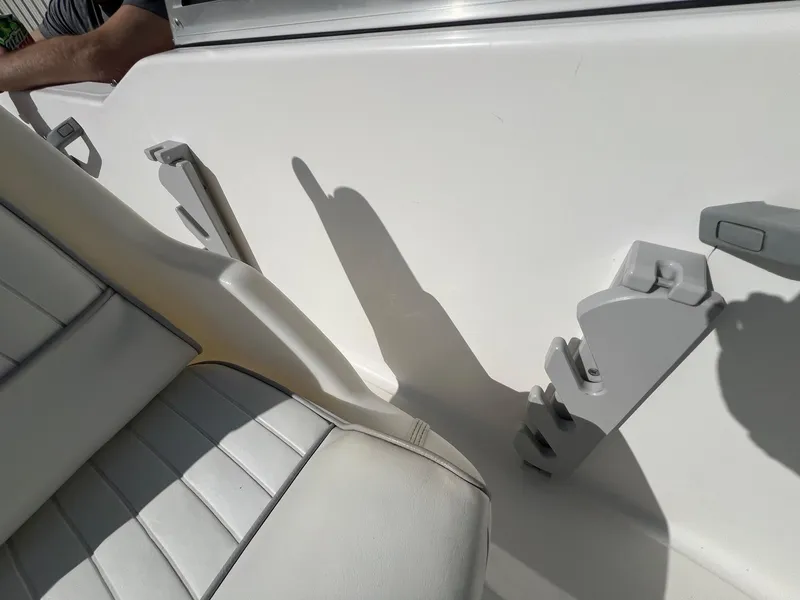 Slide: The Image of 1995 Boston Whaler 170 Dauntless interior with white seating and rod holders. - 27