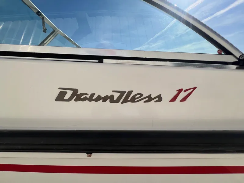 Slide: The Image of Boston Whaler 170 Dauntless 1995 boat logo with clear sky background. - 3