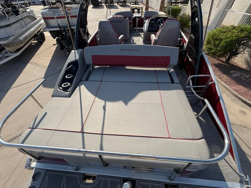 Slide: The Image of 2021 Bennington 25 QSBA IO boat interior with seating and cup holders. - 11