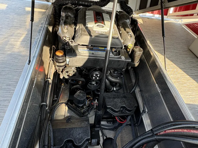 Slide: The Image of Engine compartment of a 2021 Bennington 25 QSBA IO boat, showcasing detailed mechanical components. - 12