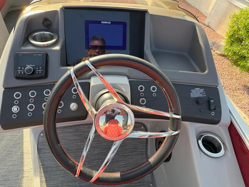 Slide: The Image of Steering console of 2021 Bennington 25 QSBA IO boat with modern controls and display. - 14