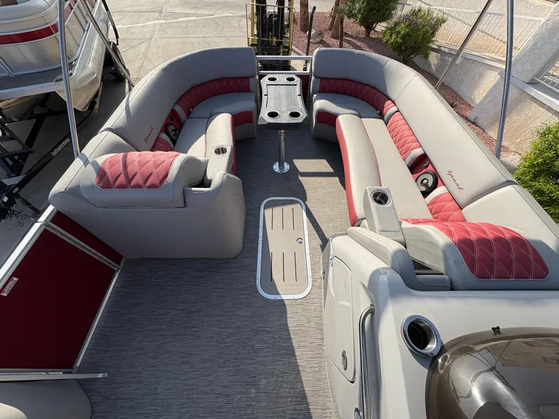 Slide: The Image of 2021 Bennington 25 QSBA IO pontoon boat with red and gray seating, spacious layout. - 7