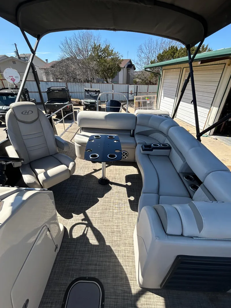 Slide: The Image of 2019 Harris Sunliner 240 pontoon boat with spacious seating and table, ideal for leisure outings. - 10