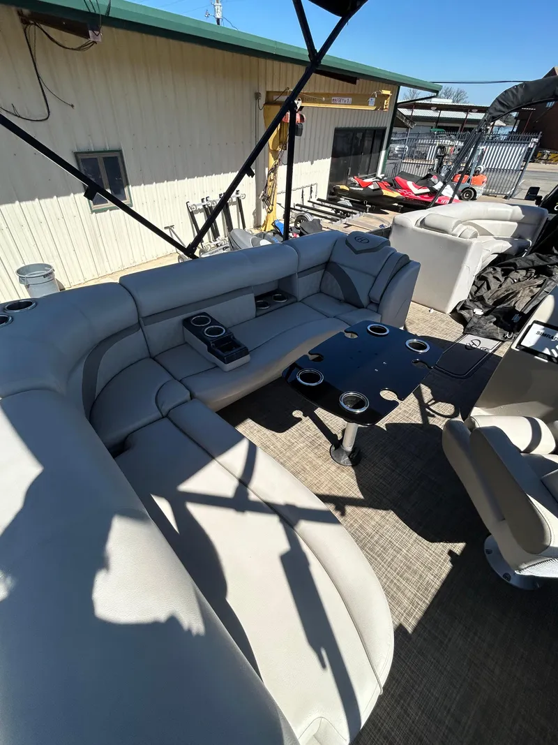 Slide: The Image of 2019 Harris Sunliner 240 boat interior with plush seating and cup holders. - 17