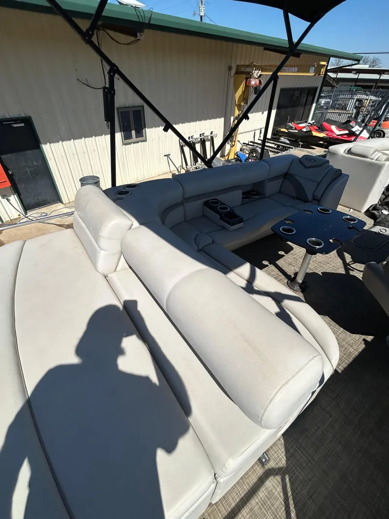 Slide: The Image of 2019 Harris Sunliner 240 pontoon boat with spacious seating and cup holders. - 18
