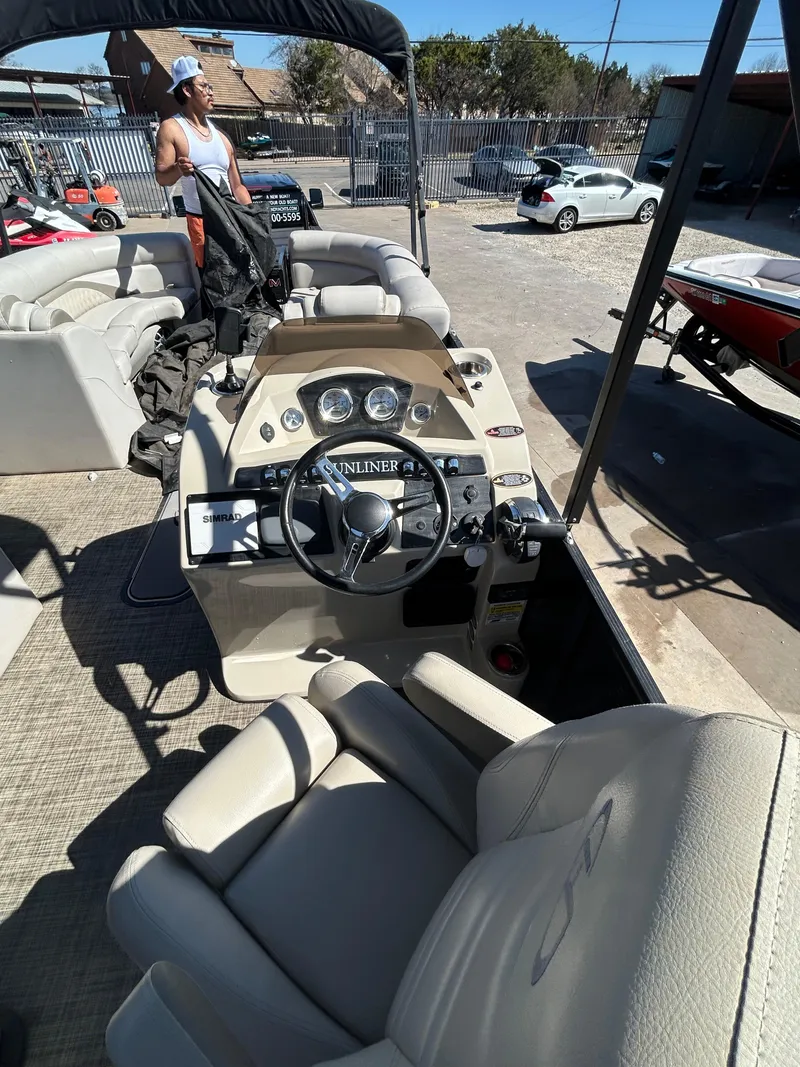 Slide: The Image of 2019 Harris Sunliner 240 pontoon boat interior with steering console and seating. - 21