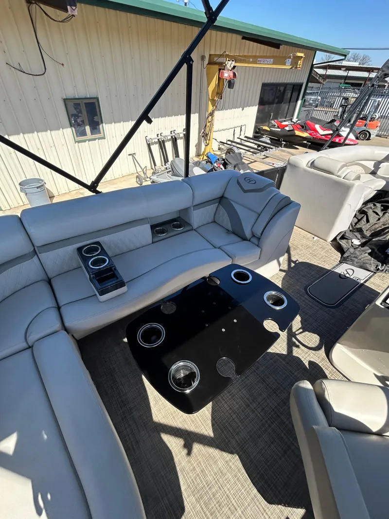 Slide: The Image of 2019 Harris Sunliner 240 interior with plush seating and cup holders. - 22